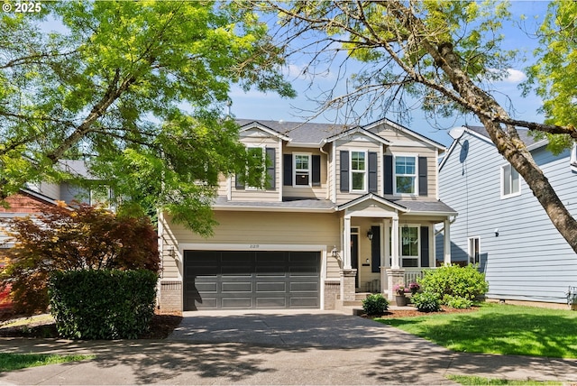 craftsman-style house featuring a garage, driveway, and brick siding