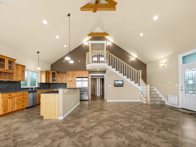 kitchen featuring pendant lighting, stainless steel appliances, dark countertops, glass insert cabinets, and a kitchen island