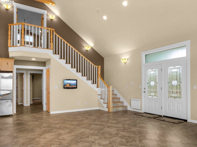 entryway with high vaulted ceiling, stairway, recessed lighting, and baseboards