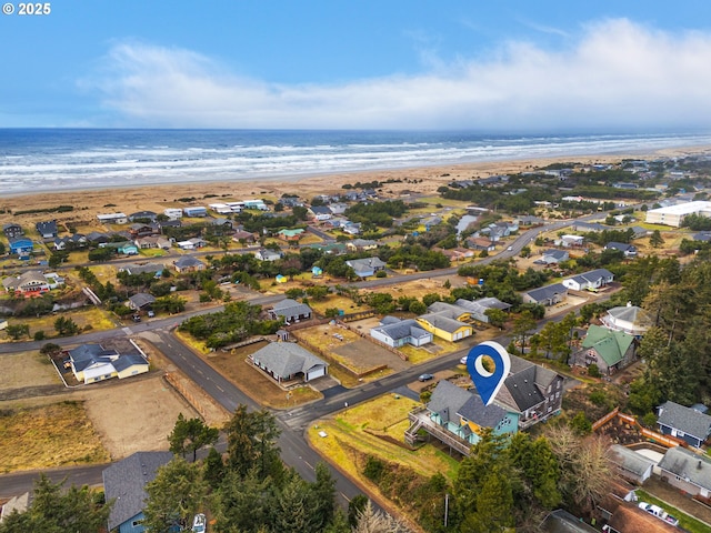 birds eye view of property featuring a beach view, a residential view, and a water view