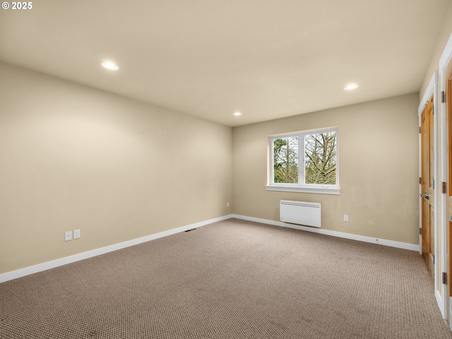 carpeted empty room featuring recessed lighting and baseboards