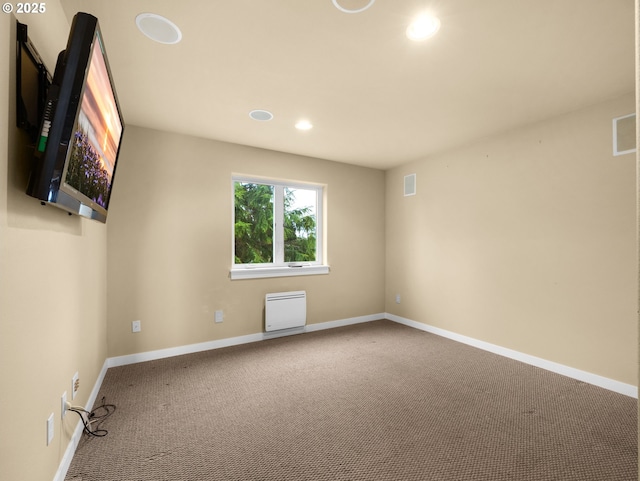 spare room featuring carpet floors, recessed lighting, visible vents, and baseboards