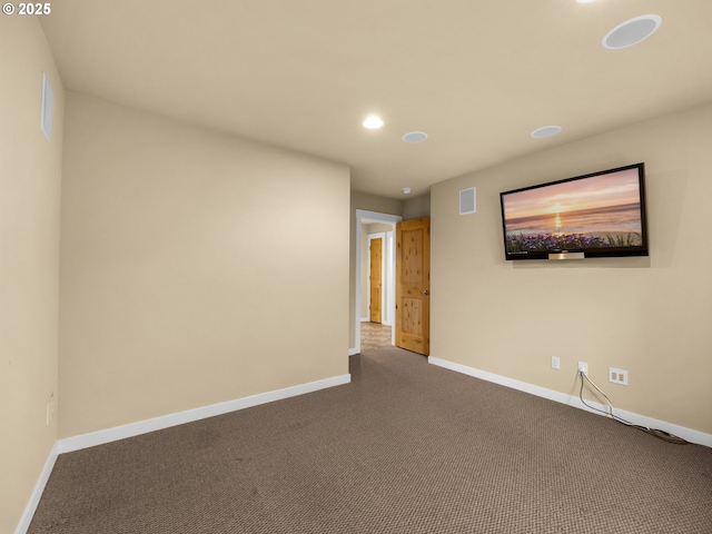 spare room featuring recessed lighting, carpet, visible vents, and baseboards