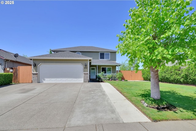 traditional-style home with concrete driveway, an attached garage, a front lawn, and fence