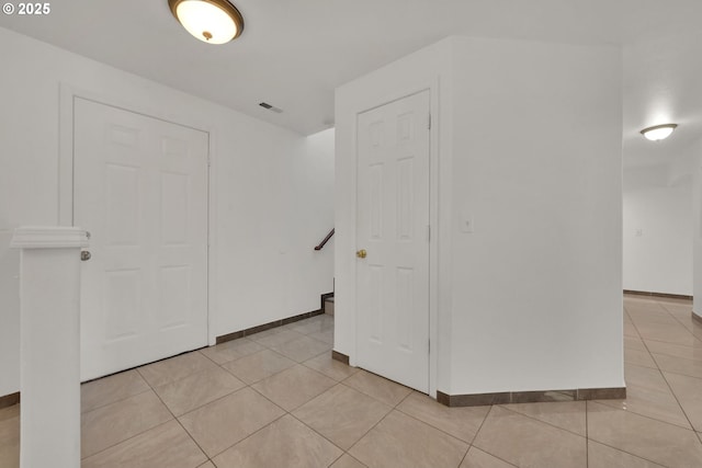 unfurnished room with light tile patterned floors, baseboards, and visible vents