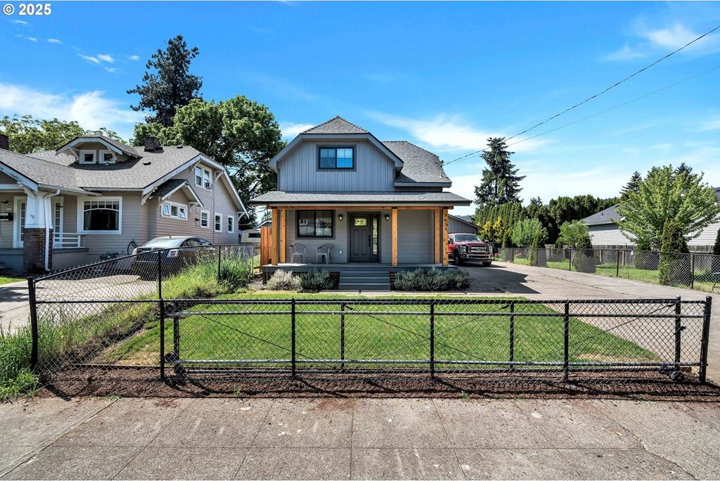 7634 N Willamette Blvd, Portland, OR 97203 - view of front of house featuring covered porch, board and batten siding, and asphalt driveway