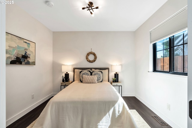 bedroom featuring dark wood-type flooring and baseboards