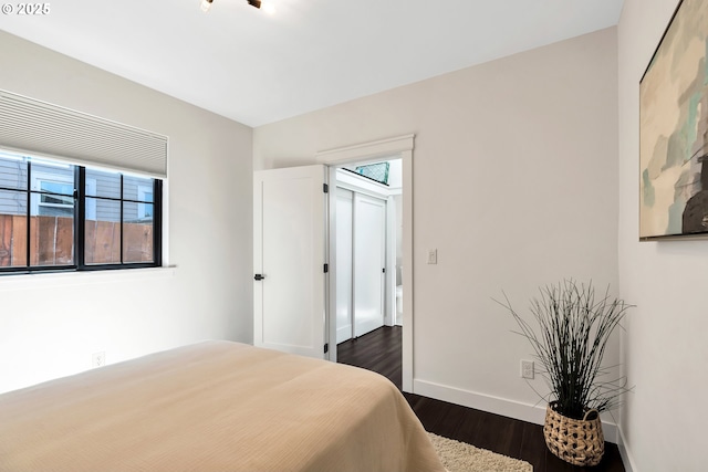 bedroom featuring dark wood-type flooring and baseboards