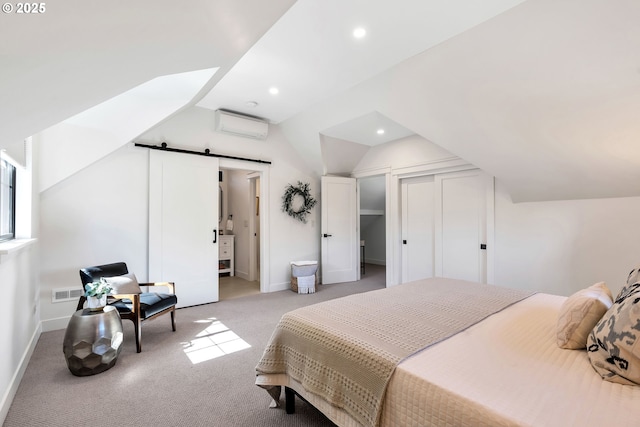 carpeted bedroom featuring lofted ceiling, a barn door, recessed lighting, baseboards, and a wall unit AC