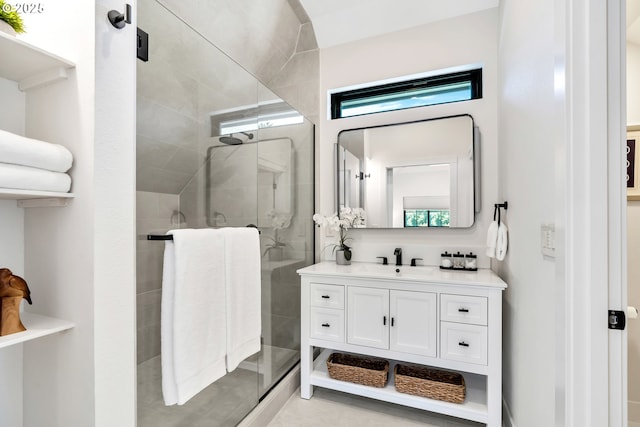 full bathroom with a shower stall, vanity, and tile patterned flooring