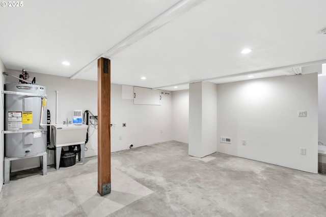 finished below grade area featuring water heater and recessed lighting