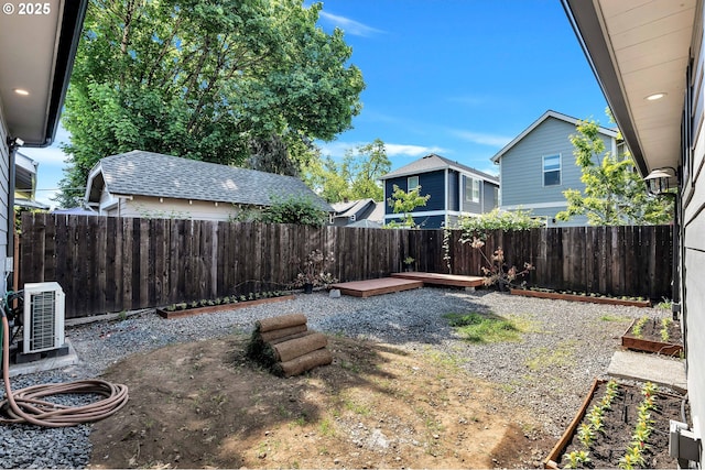 fenced backyard featuring ac unit