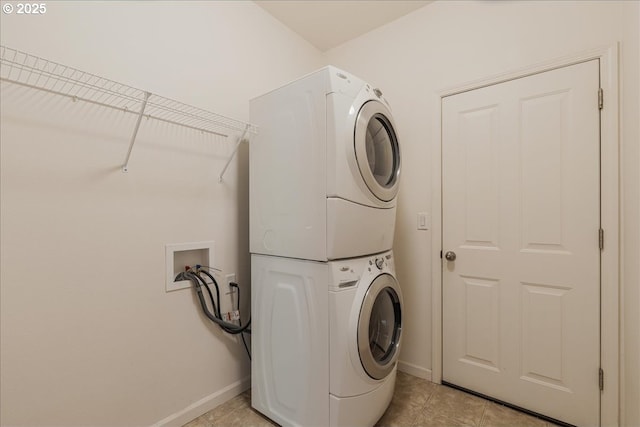 5944 SE Thornapple St, Hillsboro, OR 97123 - washroom with stacked washer and clothes dryer, baseboards, and light tile patterned flooring