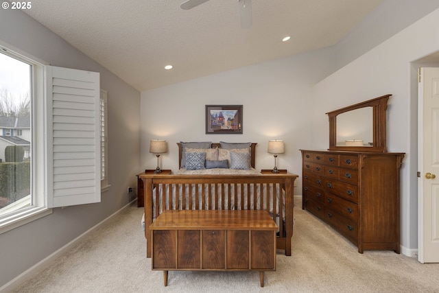 bedroom featuring light carpet, vaulted ceiling, baseboards, and multiple windows