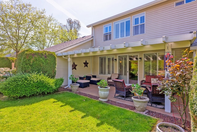 rear view of property with a patio area, outdoor lounge area, and a lawn