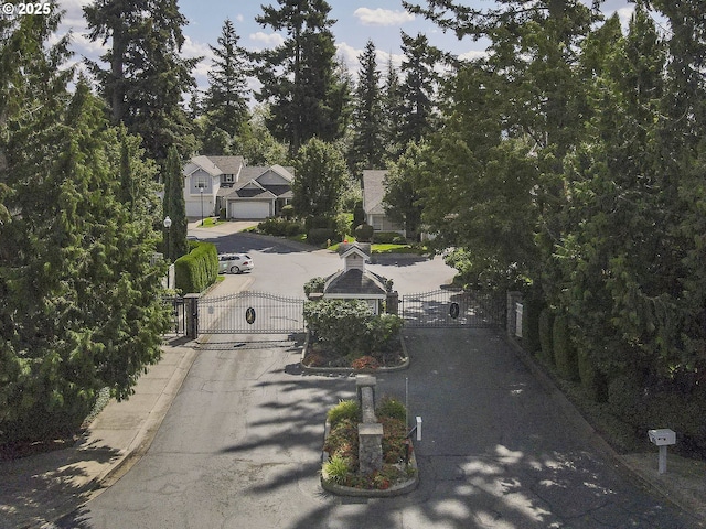 exterior space with a gate, a gated entry, and curbs