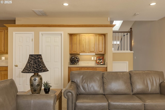 living area with visible vents and recessed lighting