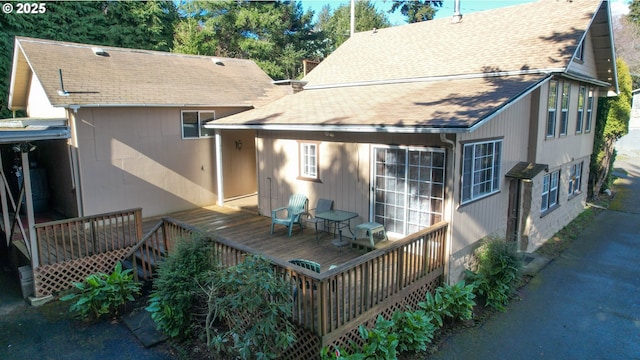 rear view of house featuring a deck