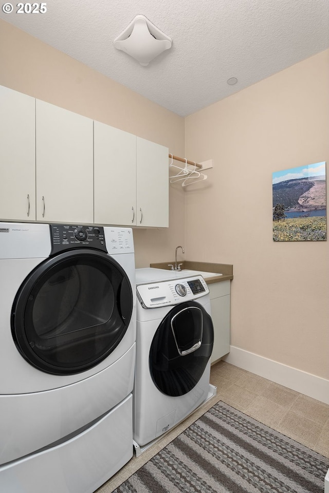 10480 SW Windwood Way, Portland, OR 97225 - washroom with washer and clothes dryer, cabinet space, and a textured ceiling