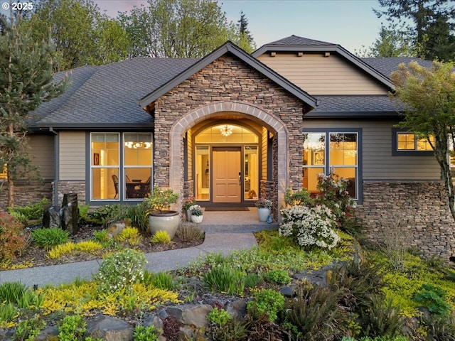 9522 NW Skyview Dr, Portland, OR 97231 - property entrance featuring stone siding and a shingled roof