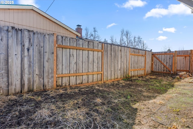 view of yard featuring fence and a gate