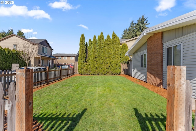 view of yard with a residential view and fence