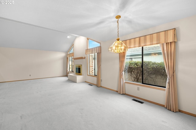 carpeted spare room with lofted ceiling