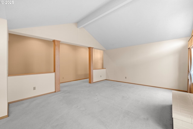 bonus room featuring light carpet, vaulted ceiling with beams, and ornate columns