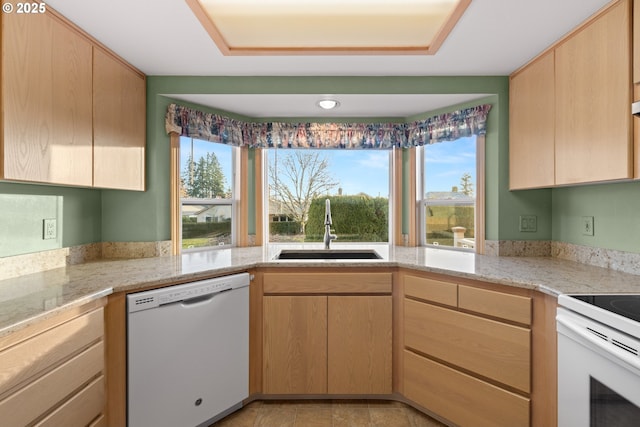 kitchen featuring sink, light brown cabinets, white appliances, and light stone counters