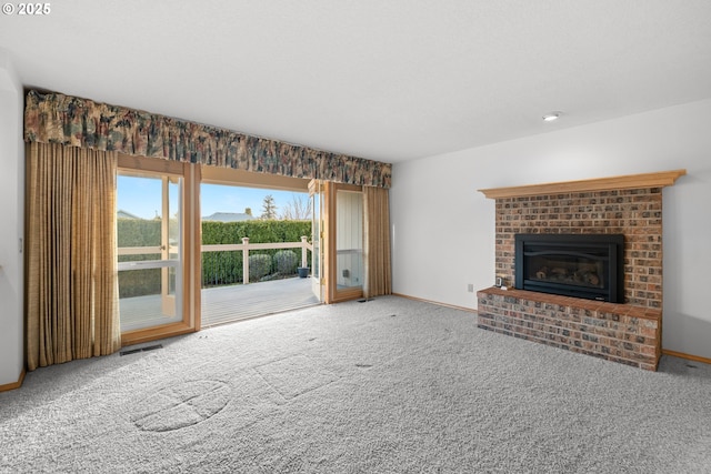 unfurnished living room with a brick fireplace and carpet