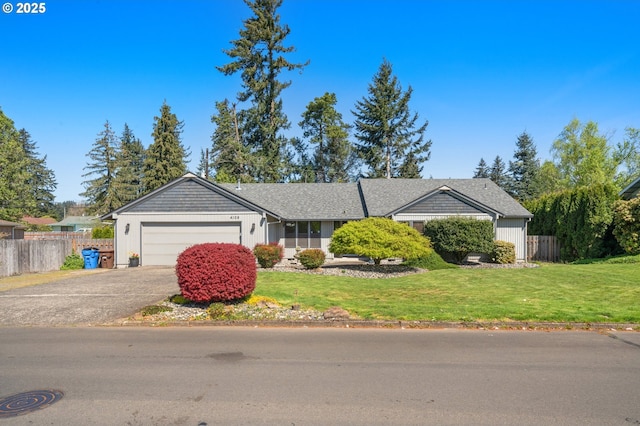 ranch-style house with an attached garage, driveway, fence, and a front lawn