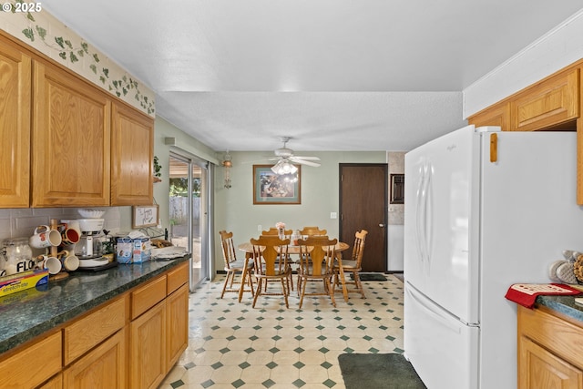 231 NE Chestnut Ave, Myrtle Creek, OR 97457 - kitchen with freestanding refrigerator, light flooring, tasteful backsplash, and ceiling fan