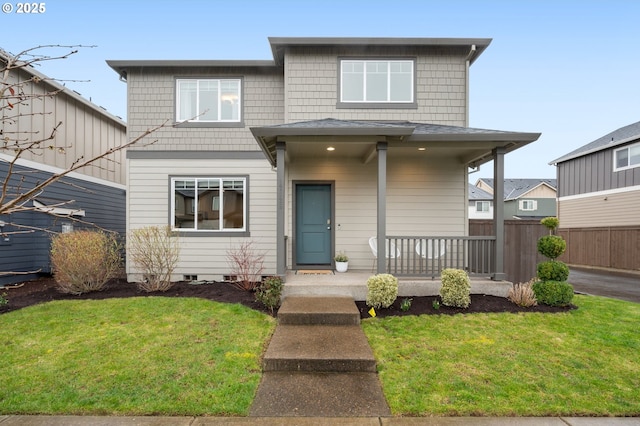 view of front of property with covered porch, a front lawn, and fence