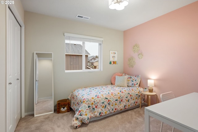 bedroom featuring visible vents, a closet, and carpet floors