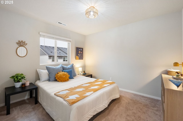 bedroom with visible vents, baseboards, and carpet