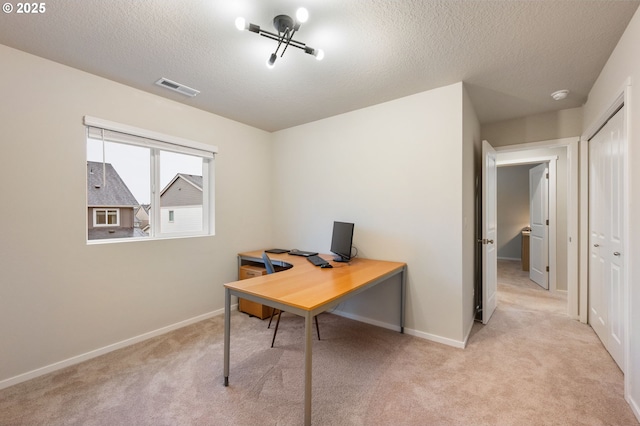 carpeted home office featuring baseboards, visible vents, and a textured ceiling