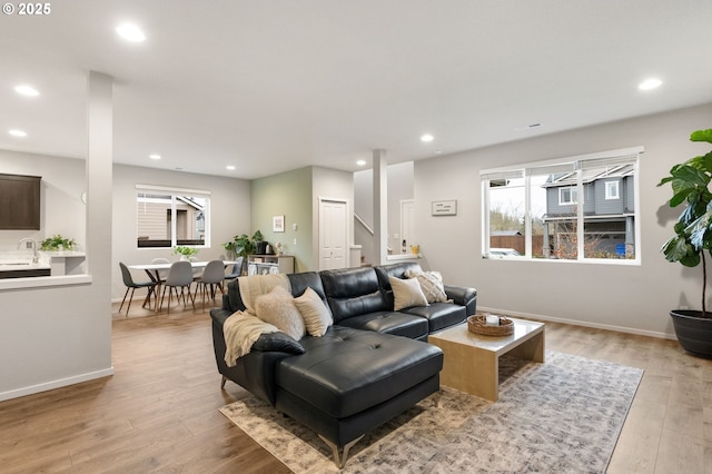 living area with recessed lighting, baseboards, and light wood-style floors