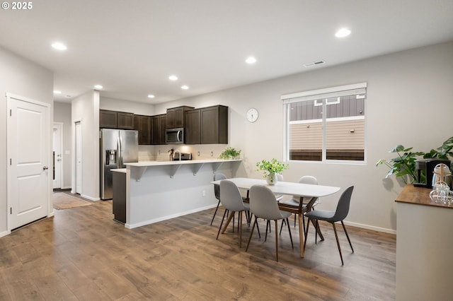 dining room with recessed lighting, visible vents, baseboards, and wood finished floors