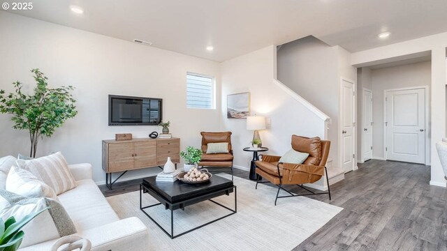 living area with wood finished floors, baseboards, and recessed lighting