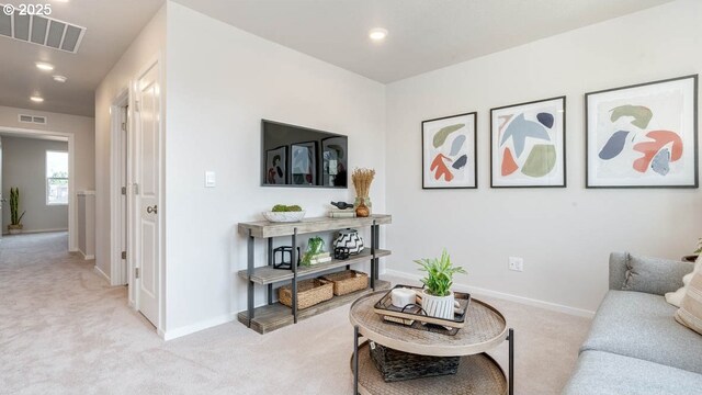 living room featuring light carpet, baseboards, and recessed lighting
