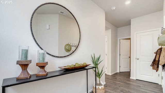 corridor with wood finished floors and baseboards