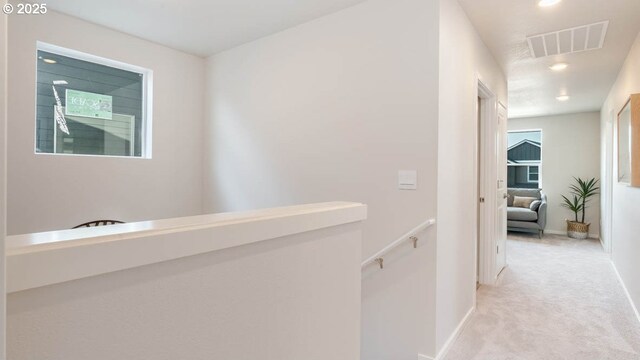 corridor with an upstairs landing, carpet flooring, baseboards, and recessed lighting