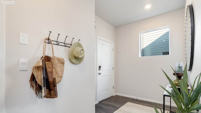 mudroom with dark wood-style floors and baseboards
