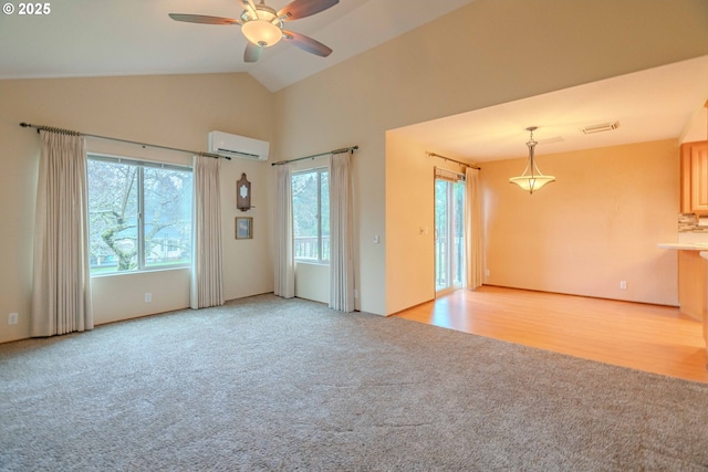 interior space featuring visible vents, high vaulted ceiling, a wall unit AC, light colored carpet, and ceiling fan