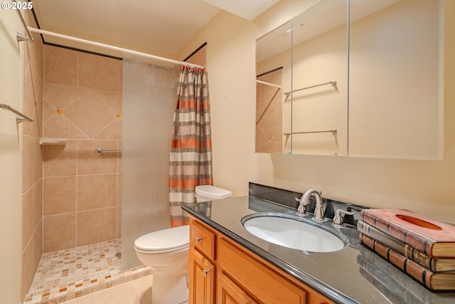 full bath featuring vanity, toilet, and a tile shower