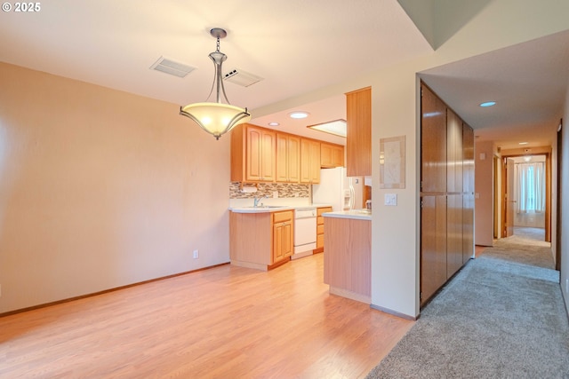 kitchen featuring visible vents, light brown cabinetry, white appliances, light wood finished floors, and light countertops