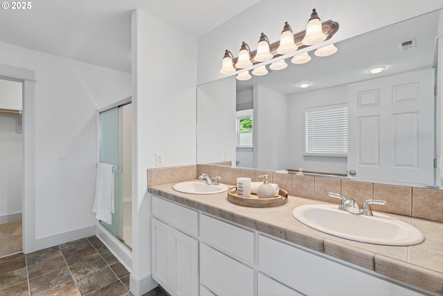 4345 SW Vino Pl, Beaverton, OR 97078 - full bathroom with a shower stall, double vanity, baseboards, and stone finish flooring