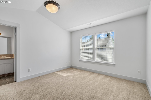 4345 SW Vino Pl, Beaverton, OR 97078 - unfurnished bedroom featuring carpet flooring, a sink, lofted ceiling, connected bathroom, and baseboards