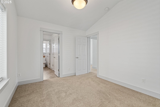 4345 SW Vino Pl, Beaverton, OR 97078 - unfurnished bedroom featuring carpet floors, vaulted ceiling, baseboards, and ensuite bath