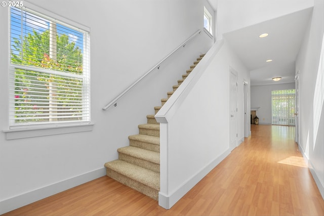 4345 SW Vino Pl, Beaverton, OR 97078 - staircase with wood finished floors, baseboards, and recessed lighting